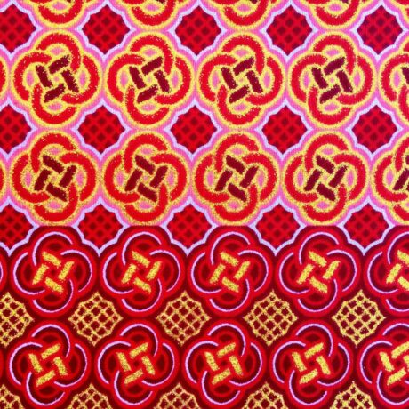 Tissu Wax pailleté rouge orangé imprimé Celte détail bordure