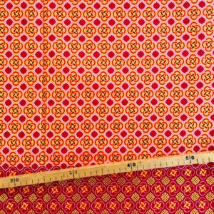 Tissu Wax pailleté rouge orangé imprimé Celte