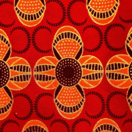 Tissu Wax pailleté rouge orange imprimé Fleurs détail
